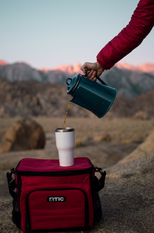 Rtic cooler and coffee mug at sunrise 